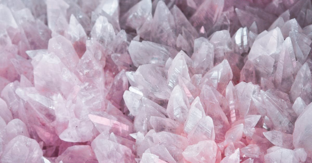 A detailed close-up of rose quartz crystals showcasing their pink hues and translucent nature.